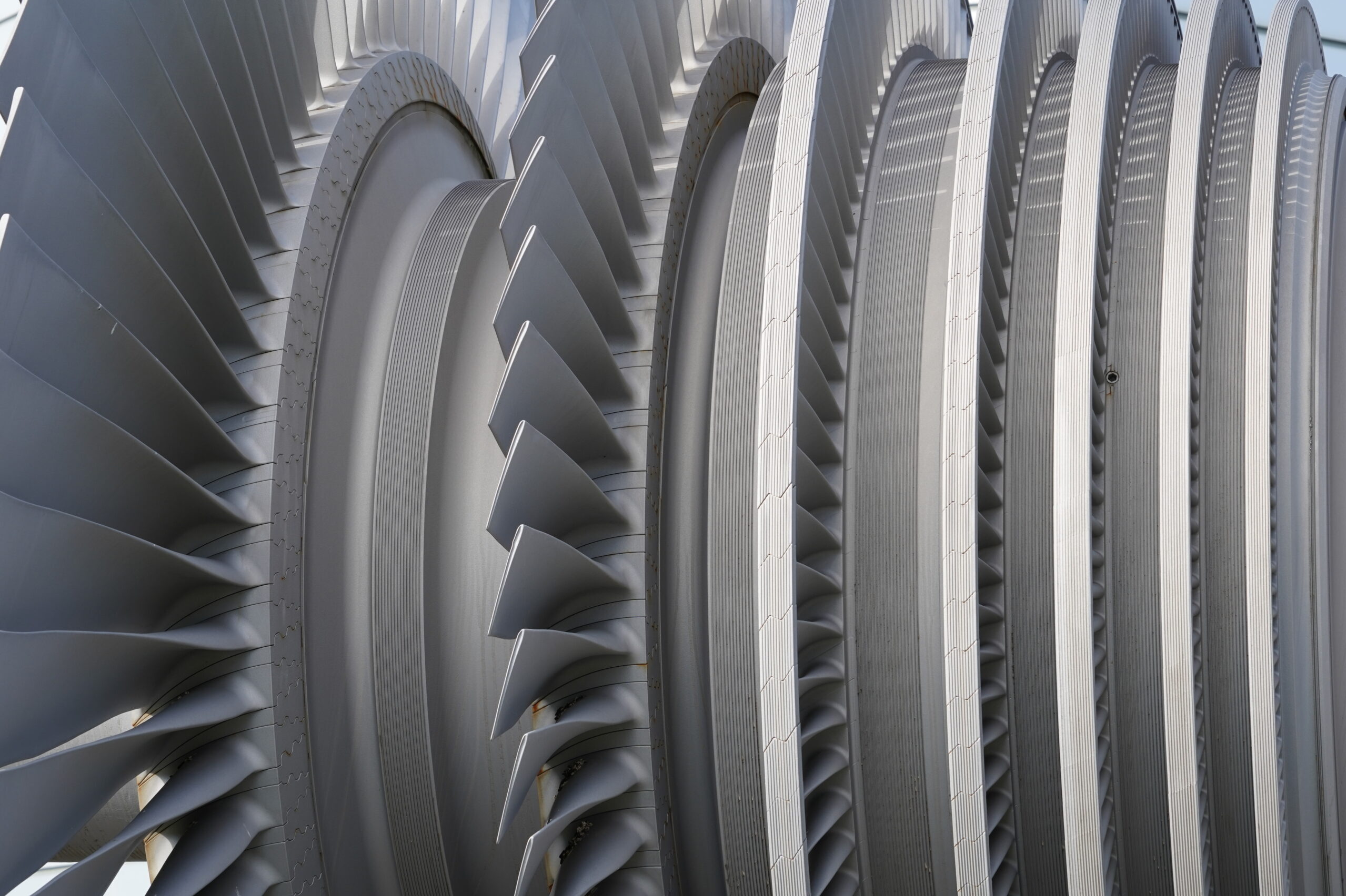 Close view on low-pressure turbine rotor with shrouded and standing blades used in nuclear power plant.